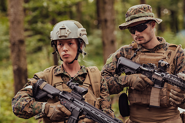 Image showing Modern Warfare Soldiers Squad Running in Tactical Battle Formation Woman as a Team Leader