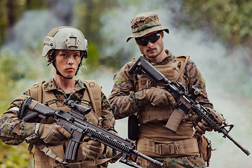 Image showing Modern Warfare Soldiers Squad Running in Tactical Battle Formation Woman as a Team Leader