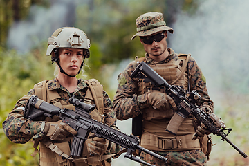 Image showing Modern Warfare Soldiers Squad Running in Tactical Battle Formation Woman as a Team Leader