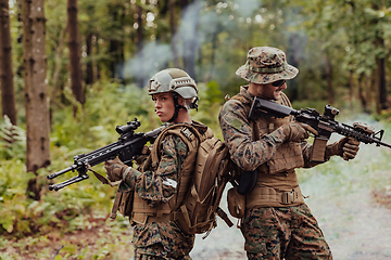 Image showing Modern Warfare Soldiers Squad Running in Tactical Battle Formation Woman as a Team Leader