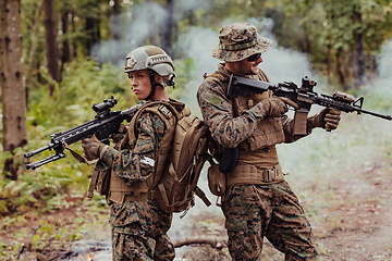 Image showing Modern Warfare Soldiers Squad Running in Tactical Battle Formation Woman as a Team Leader