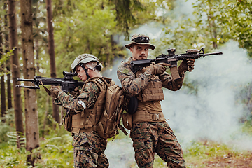 Image showing Modern Warfare Soldiers Squad Running in Tactical Battle Formation Woman as a Team Leader