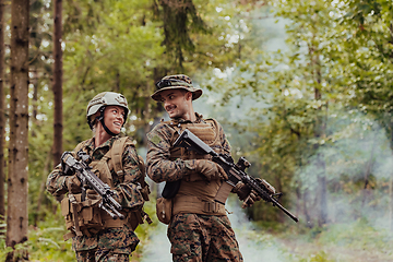 Image showing Modern Warfare Soldiers Squad Running in Tactical Battle Formation Woman as a Team Leader