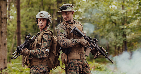 Image showing Modern Warfare Soldiers Squad Running in Tactical Battle Formation Woman as a Team Leader