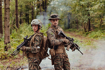 Image showing Modern Warfare Soldiers Squad Running in Tactical Battle Formation Woman as a Team Leader