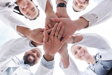 Image showing Hospital doctors, happy people and circle hands together for healthcare teamwork, medical team building and clinic celebration. Solidarity, below view and group surgeon for collaboration success