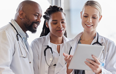 Image showing Smile, healthcare and doctors reading on a tablet for results, medical advice or planning. Happy, typing and a surgeon with African employees and technology for help, collaboration or cardiology