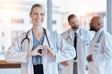 Image showing Healthcare, heart and hands with portrait of doctor in hospital for medical, support and kindness. Motivation, wellness and medicine with woman and gesture in clinic for cardiology, care and emoji