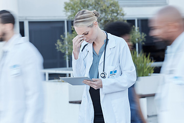 Image showing Tablet, doctor and woman with stress in busy hospital, fatigue and burnout. Tech, medical professional and person with problem, crisis or challenge, headache and anxiety for mistake, fail or accident