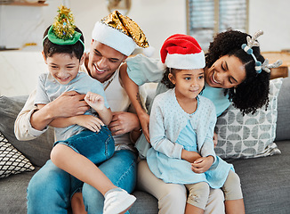 Image showing Parents, kids and playing on sofa, christmas or tickling with comic laughing, game or excited in family home. Mother, father and happy young children with xmas celebration, relax and bonding or couch