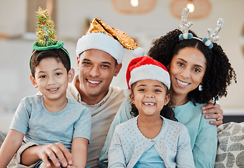 Image showing Family home, parents and kids in Christmas portrait, hat or smile on sofa for celebration in living room. Mother, father and happy young children for xmas party, event or holiday for culture on couch