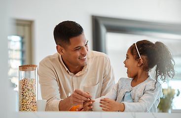 Image showing Happy family, father and child eating breakfast and talking of school, growth development and health at home. Dad helping kid or girl with cereal or morning food and funny conversation in kitchen