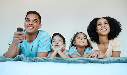 Image showing Mom, dad and children on bed, watching tv and smile for comedy, funny movie or cartoon in family house. Happy parents, kids and watch television show with streaming, subscription and relax together