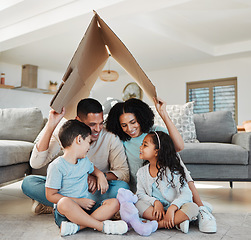 Image showing Happy family, children and parents with home insurance, investment and safety or love on floor with mother and father. Kids and interracial people with cardboard roof for house cover and security