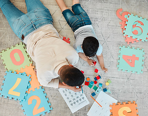 Image showing Building blocks, top or father with kid on the floor for learning, education or child development at home. Family, play or dad enjoying bonding time in living room with boy or toys doing homework