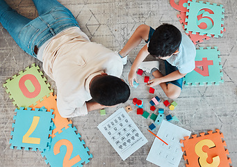 Image showing Building blocks, above or father with kid on the floor for learning, education or child development at home. Family, play or dad enjoying bonding time in living room with boy or toys doing homework