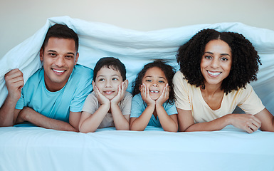 Image showing Blanket, bed and portrait of parents with children for bonding, quality time and affection in morning. Love, family and happy mother, father and kids laying in bedroom for fun, playful and relaxing