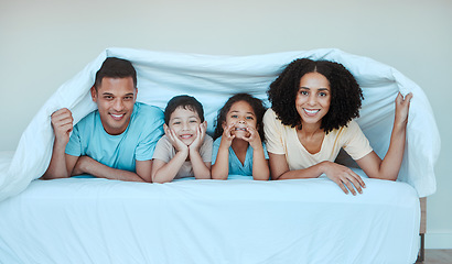 Image showing Happy, blanket and portrait of family in bed for bonding, quality time and affection in morning. Parent, love and playful mother, father and kids in bedroom for having fun, sleeping and relaxing