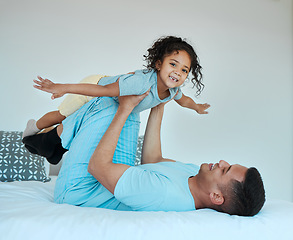 Image showing Bedroom, airplane and portrait of father playing with child for quality time, fun or happiness at home. Happy, smile and young dad relaxing with boy kid in a superhero costume on bed at family house.