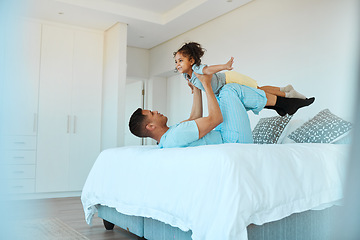 Image showing Airplane, bonding and father playing with his child for quality time, fun or happiness at home. Happy, smile and young dad relaxing with his boy kid in a superhero costume on the bed at family house.