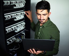 Image showing Laptop, data center and male technician in a server room for technical repairs by a control box. Technology, engineering and professional man electrician working on computer for cybersecurity system.