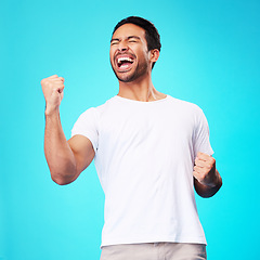 Image showing Happy asian man, winner and fist in studio for celebration, achievement and success on blue background. Excited model shout to celebrate winning prize, deal and victory of lottery, reward and bonus