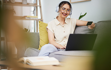 Image showing Happy woman, credit card and laptop with headphones in home for ecommerce sales, fintech password and online shopping. Female customer, computer banking and code to upgrade music subscription account