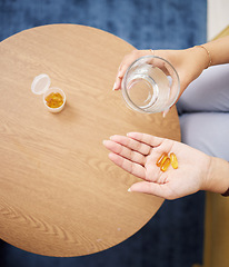 Image showing Top view of hands, pills and water in glass for sick woman, iron supplements and cure at home. Capsule tablets, prescription drugs and vitamins in palm for wellness product, medicine and healthcare