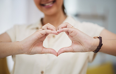 Image showing Closeup, heart and hands of woman for care, charity and kindness of donation at home. Female person with finger shape for love icon, thank you and emoji reaction in support of freedom, review or hope