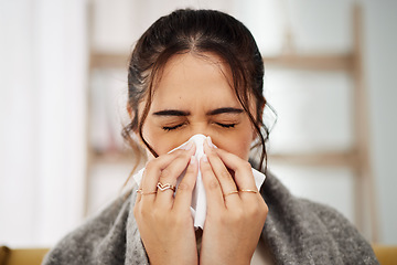 Image showing Tissue, nose and sick woman sneezing in living room with allergy, cold or flu in her home. Hay fever, sinusitis and female with viral infection, risk or health crisis in lounge with congestion