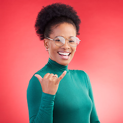 Image showing Portrait, excited and black woman with call me hand in studio isolated on a red background with glasses. Face, happy and African person with shaka gesture, emoji sign and phone for communication