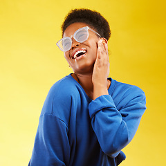 Image showing Fashion, freedom and excited with a black woman on a yellow background in studio for trendy gen z style. Relax, smile and fun with a happy young girl indoor to dance with a carefree expression