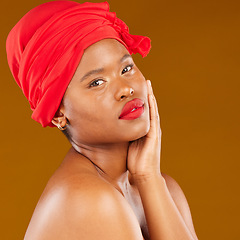 Image showing Beauty, woman and trendy wrap with face and red lips portrait and scarf for care and wellness in studio. Brown background, female person and cosmetics with African model and makeup for facial glow