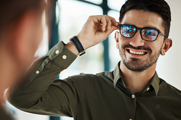 Image showing Face, man and smile with glasses in mirror for vision, eyesight and prescription lens. Happy male customer with choice of frame for designer eyewear, optical fashion and assessment in eye care clinic