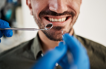 Image showing Smile, man and hands of dentist with tools for dental, healthcare or check in clinic. Tooth wellness, orthodontics and patient with doctor, mirror and excavator for teeth cleaning and medical hygiene