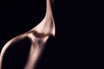 Image showing Beauty, neck and person on black background for creative lighting, shadow and silhouette. Aesthetic, fantasy and closeup of body in dark studio with macro of skin for art deco, wellness and glow