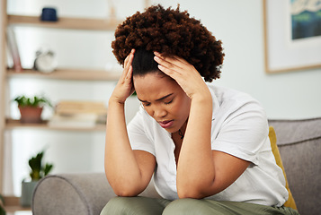 Image showing Stress, headache and woman on a sofa in the living room of her modern apartment with a burnout. Sick, migraine and exhausted young African female person relaxing on weekend in the lounge of her home.