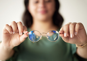 Image showing Hands, woman and glasses for optometry or vision with reading for focus with prescription. Eye, care and female person holding spectacle in closeup for sight with frames for eyesight or wellness.