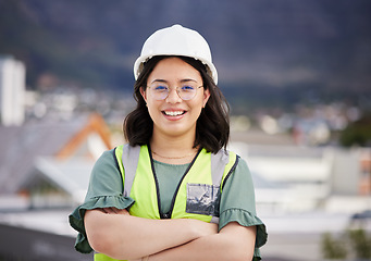 Image showing Engineering, crossed arms and portrait of a female construction worker on a building rooftop. Confidence, industry and woman industrial manager for maintenance, renovation or inspection in the city.