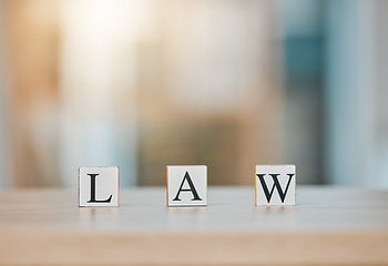 Image showing Table, office and block cubes with law letter in office with blur background for customer or business. Support, service and frequently asked questions for regulation with company in mock up space.