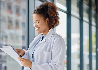 Image showing Woman, doctor and reading healthcare documents for hospital administration, research paper and review. Happy black female medical worker planning checklist of insurance report, test results or script