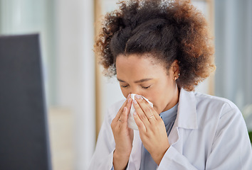 Image showing Woman, sick doctor and blowing nose in hospital with allergy, influenza or virus. Black female healthcare professional, tissue and allergies in clinic for problem, cold and bacteria in medical office