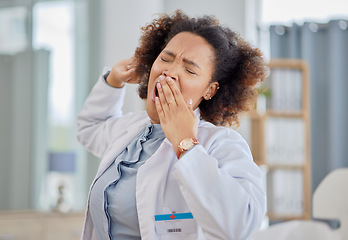 Image showing Tired doctor, woman and yawn in hospital with burnout, medical stress and working with low energy in clinic. Fatigue of black female healthcare worker yawning while feeling overworked, sleepy or lazy