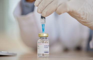 Image showing Smallpox vaccine, vial and hands of doctor for safety, healthcare or medicine in hospital. Closeup, nurse and prepare vaccination, virus injection and bottle for immunity, medical development or help