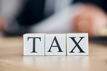 Image showing Taxes, finance and accounting with building blocks on desk for payment, planning and economy. Budget, growth and insurance with closeup text on wooden toys in office for investment, audit and report