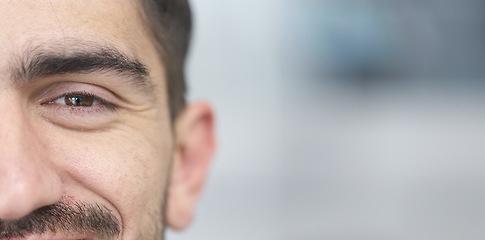 Image showing Face, eyes and mockup with a man closeup for future vision or eyesight while looking happy or positive. Portrait, half and space with a young male person on a mock up banner for optometry or eye care