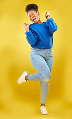 Image showing Happy, dance or black woman in studio for celebration, achievement or goal with confidence. Moving, smile or African female model with pride, success or joy for target isolated by yellow background