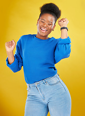 Image showing Happy, dance and young woman in studio for celebration, achievement or goal with confidence. Happiness, smile and African female model moving to music, song or playlist isolated by yellow background.