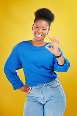 Image showing Portrait, black woman and ok sign with a smile, review and feedback against a yellow studio background. Female person, gen z and model with perfect symbol, emoji and happiness with like, icon and yes