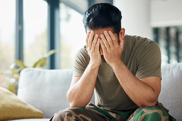 Image showing Military, army and a man with trauma and depression while sitting on a sofa with mental health or stress. Soldier, psychology and a male person with anxiety, fear and frustration or ptsd crisis